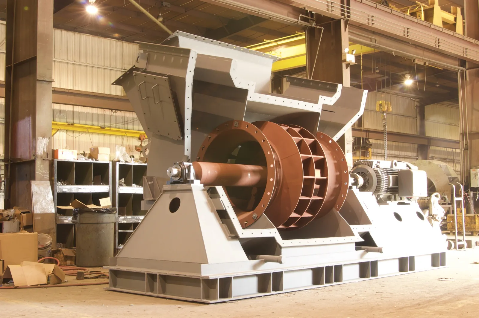 Large centrifugal fan assembly with exposed impeller and motor on a fabricated base in the Barron Fan shop