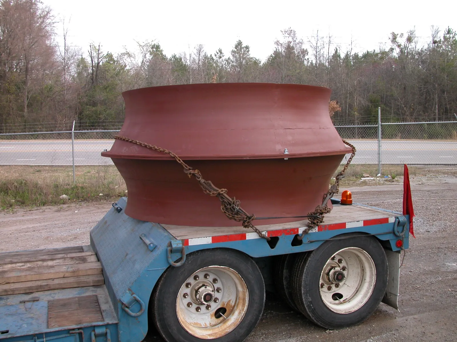 Primer-red spun inlet cone fabricated at Barron Fan, secured for transport