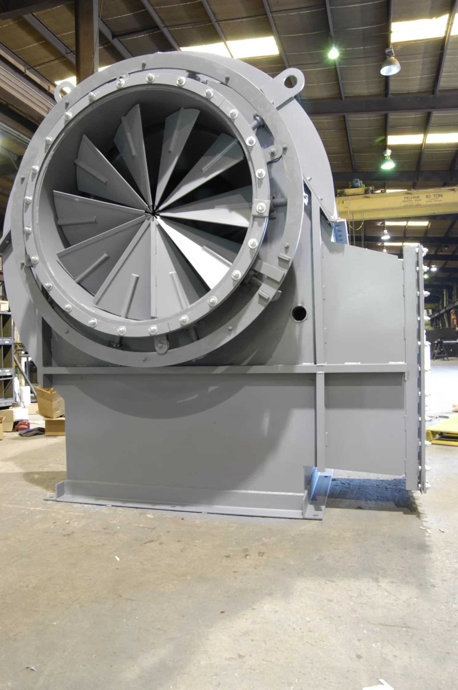 Newly built centrifugal fan with inlet cone and impeller, finished in gray, on the Barron Fan shop floor
